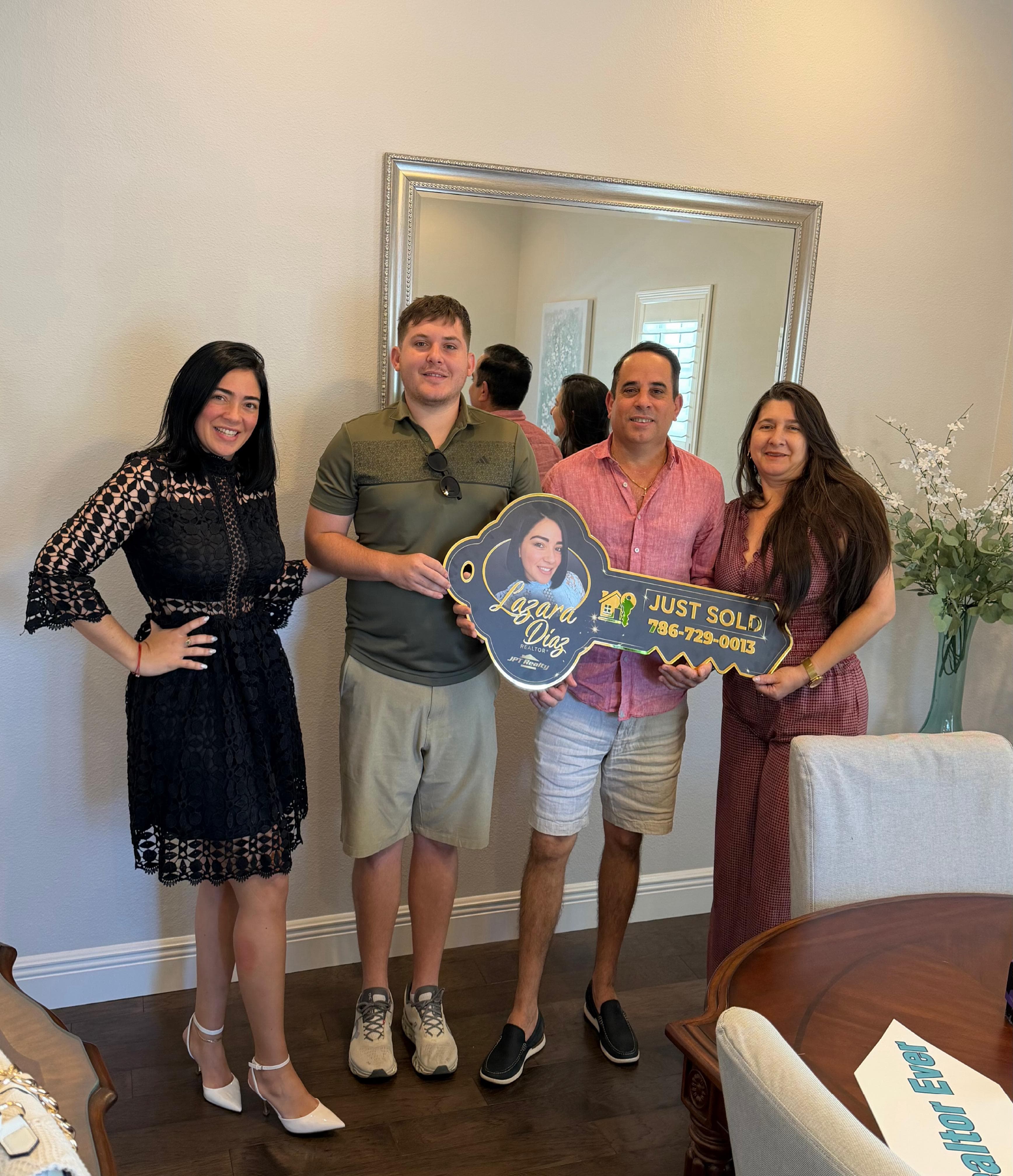 Lazara Diaz Tampa Bay Realtor with client on closing day holding Closing Day key