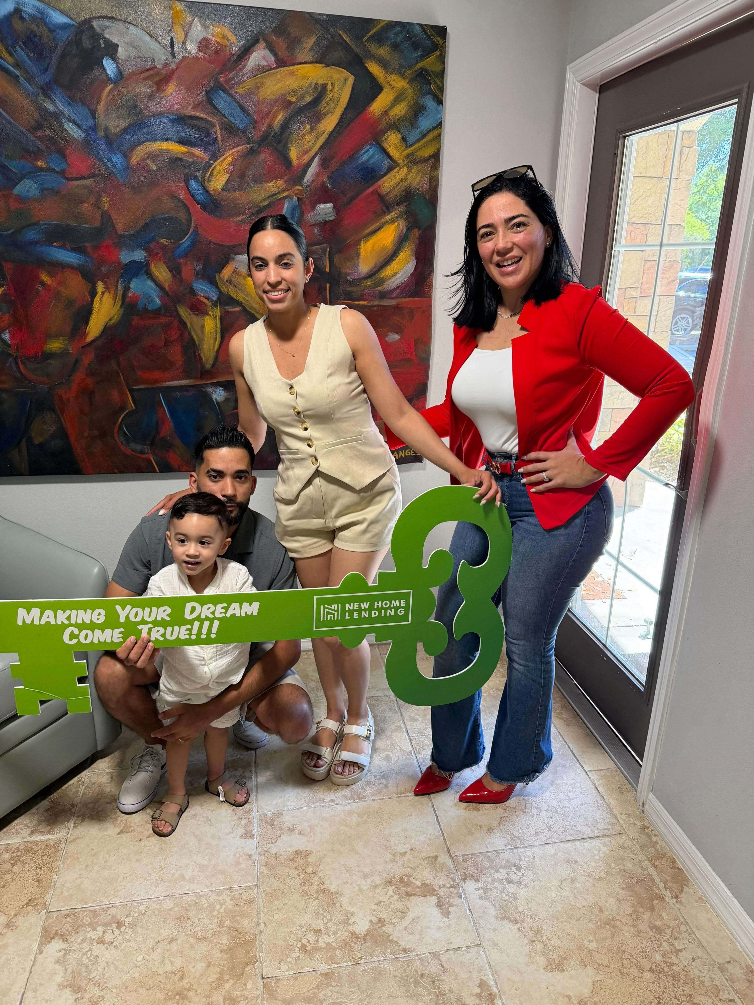 Lazara Diaz Tampa Bay Realtor celebrating closing day with client holding Just Closed sign
